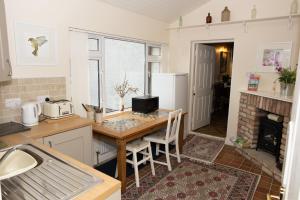 a kitchen with a table and a counter top at Dromard House in Enniskillen