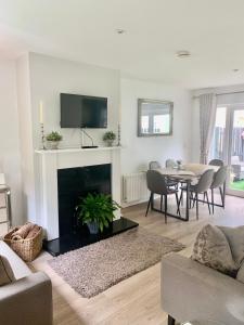 a living room with a fireplace and a table with chairs at No.14 in Bunratty