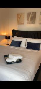 a large bed with a tray of towels on it at Modern Luxury Flat in Putney in London