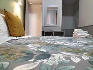 Postel nebo postele na pokoji v ubytování Hotel Camilla Guelfa