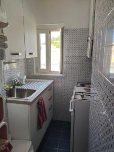 a small kitchen with a sink and a stove at VisitPonza - Olimpo in Ponza
