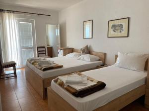 a bedroom with two beds with towels on them at Jelić apartmani in Sutomore