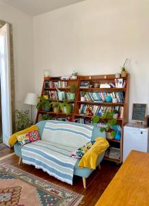 a living room with a couch and book shelves at Casa dos Caminhos de Santiago in Mosteiró