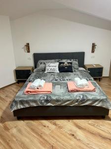 a bedroom with a bed with two towels on it at Gallery City Center Apartment in Skopje