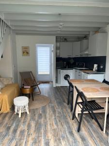 a living room with a table and a kitchen at Villa en bord de mer in Pornichet