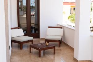 2 Stühle und ein Couchtisch in einem Zimmer in der Unterkunft La Casa di Teresa in Borgagne