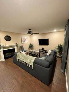 a living room with a couch and a tv at Beautiful single story 4 br. home in nice area. in Palmdale