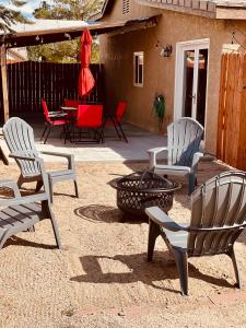 a group of chairs and a fire pit on a patio at Beautiful single story 4 br. home in nice area. in Palmdale