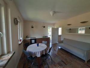 a living room with a table and a couch at Perełka in Pieszyce