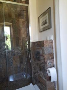a shower with a glass door in a bathroom at Perełka in Pieszyce