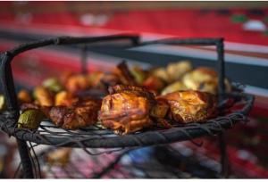 a grill with chickens and other food on it at Sami Al Muzna Rum Camp in Wadi Rum