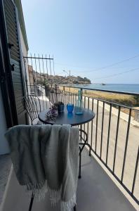 a table on a balcony with a view of the beach at Tusa Bay in Castel di Tusa