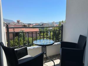 a balcony with a table and chairs and a view at Apartmani Kralj in Bar