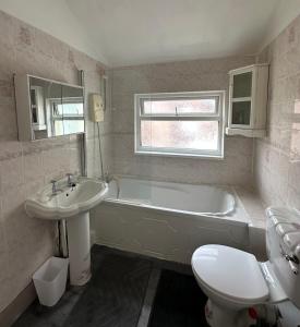 a bathroom with a tub and a sink and a toilet at Clifton Street in Middlesbrough