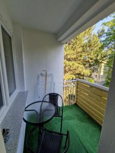 a patio with two chairs and a table on a balcony at Apartament Zdrojowy in Głuchołazy