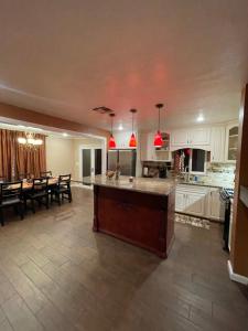 a large kitchen and dining room with a large island at Beautiful single story 4 br. home in nice area. in Palmdale