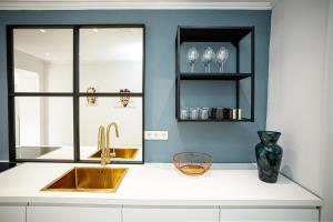 a kitchen counter with a sink and a window at Luxus Ferienwohnung "Mila" mit Moselblick und Garage für Motor- und Fahrräder in Zell an der Mosel +4 photos