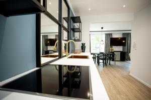 a kitchen and living room with a counter and a table at Luxus Ferienwohnung "Mila" mit Moselblick und Garage für Motor- und Fahrräder in Zell an der Mosel