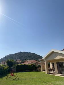 a house with a mountain in the background at House with Garden in Peratata - 10' from City Center in Peratáta