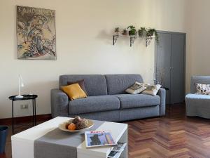 a living room with a couch and a table at Quiet in Biancamano - Casa Vacanze Roma in Rome