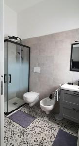 un bagno con doccia, WC e lavandino di All'ombra dell'ulivo a Monopoli