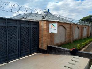 a building with two garage doors and a sign on it at The N3 Suites in Mzuzu