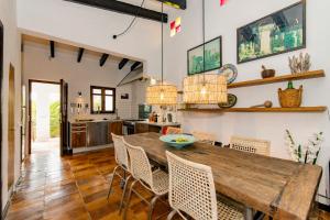 a kitchen and dining room with a wooden table and chairs at Luxurious Refuge in National Park on Island - heated Pool - 5 minutes to Ocean in Mahón