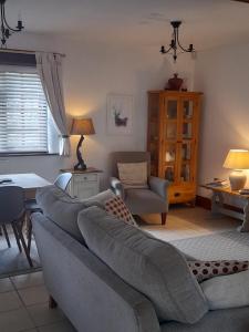 a living room with a couch and a table at Delightful Devon Cottage in East Budleigh