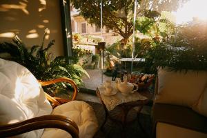 a patio with a table with a tea set on it at La casetta di Giusy - Alloggio turistico in Viterbo