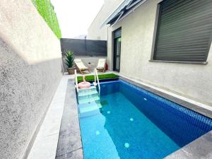 a swimming pool in the backyard of a house at Yalarent Melody- Suites with privat pools in Migdal