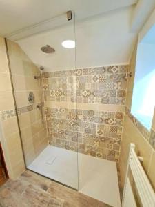 a shower with a glass door in a bathroom at Nel centro storico di Trequanda in Trequanda