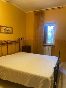 a bedroom with a bed and a window at Agriturismo Azzarone in Vieste