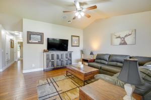 a living room with a couch and a flat screen tv at Laramie Vacation Rental about 4 Mi to Downtown! in Laramie