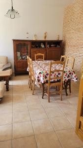 a dining room with a table and chairs at Maison proche Zoo de Beauval in Poulaines