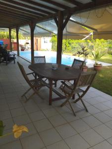 a wooden table and chairs on a patio at Zen paradise in Sainte-Anne +33 photos