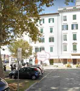 a building with a sign in front of a parking lot at Il porto di Ale e Kat in Livorno