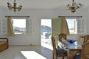 a dining room with a table and a view of the ocean at Hara Studios and Apartments in Naousa