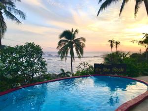 a swimming pool with a view of the ocean at Naiharn On The Rock Resort Phuket in Nai Harn Beach +27 photos