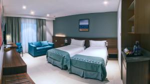 Ένα ή περισσότερα κρεβάτια σε δωμάτιο στο Boulevard Hotel Oman