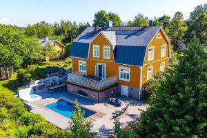 an aerial view of a house with a swimming pool at Villa Degerby - 330m2 Lux Manor w/Heated Pool, Spa in Degerby