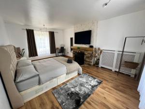 a bedroom with a bed and a flat screen tv at Large Room with free Netflix, Amazon Prime, Disney Plus in Bromley