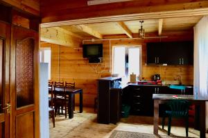 a kitchen and dining room with a table and chairs at Hillside Bakhmaro in Chʼkhakoura