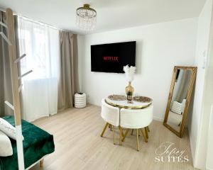 a living room with a table and a mirror at Naturally Suite in Calais