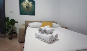 a bedroom with two beds with towels on them at Superior Design Apartment - Pigneto169 in Rome