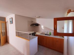 a kitchen with a sink and a counter top at Apartman Mihaela in Komiža