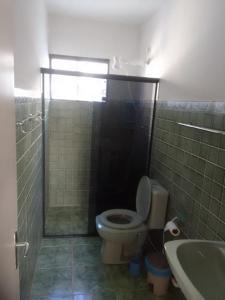 a bathroom with a toilet and a shower and a sink at Apartamento Praia do Janga Paulista Pe in Paulista