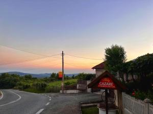 a sign for a cafe on the side of a road at Cazare Nely in Novaci-Străini