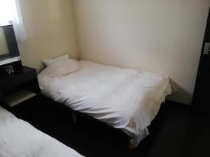Postel nebo postele na pokoji v ubytování YUFUKANⅡ
