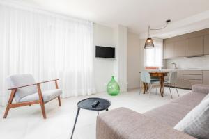 a living room with a couch and a table at Contrada del Nonno Apartments (city center - private parking on-site) in Rovinj