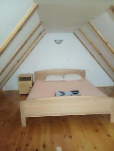 a bedroom with a bed in the attic at Katun Mokra in Podgorica